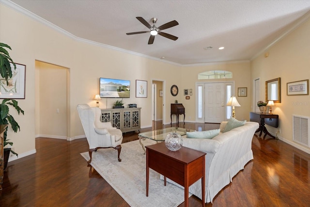 living room with crown molding, dark hardwood / wood-style floors, and ceiling fan