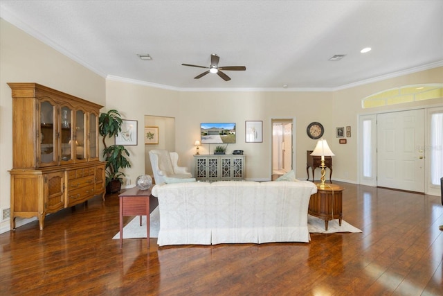 living room with crown molding, dark hardwood / wood-style floors, and ceiling fan