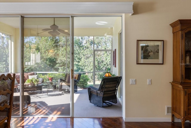 doorway to outside with ceiling fan and dark hardwood / wood-style floors