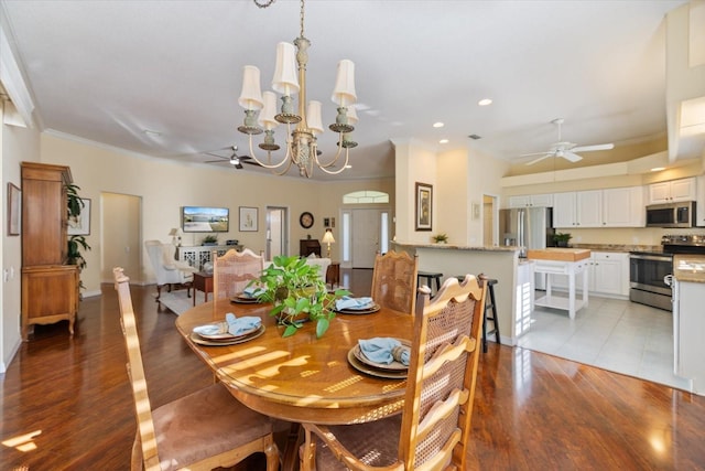 dining area with crown molding, light hardwood / wood-style floors, and ceiling fan with notable chandelier