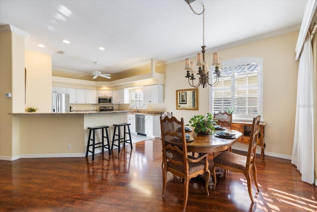 dining area with crown molding, dark hardwood / wood-style floors, and sink