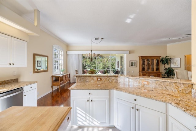 kitchen featuring decorative light fixtures, dark wood-type flooring, stainless steel dishwasher, and white cabinets