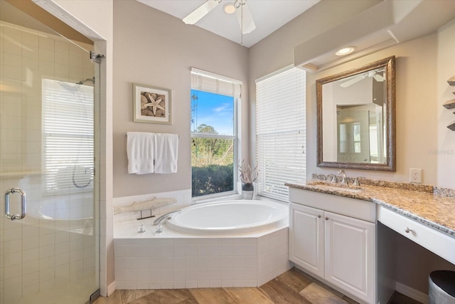 bathroom with independent shower and bath, vanity, hardwood / wood-style floors, and ceiling fan