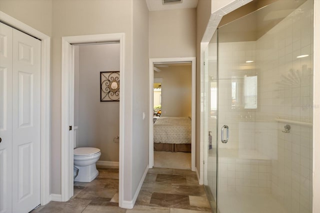 bathroom featuring an enclosed shower and toilet