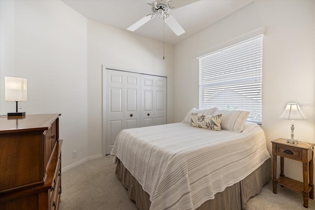 bedroom with light carpet, a closet, and ceiling fan