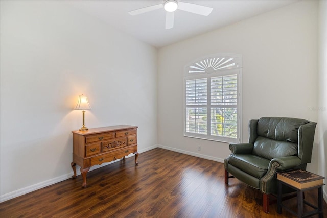 living area with dark wood-type flooring and ceiling fan