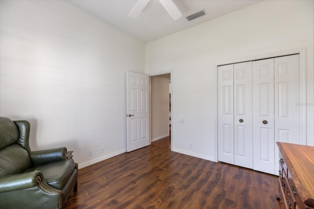 living area featuring ceiling fan and dark hardwood / wood-style flooring