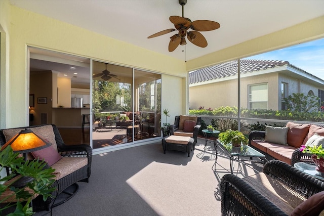 sunroom / solarium featuring a healthy amount of sunlight and ceiling fan