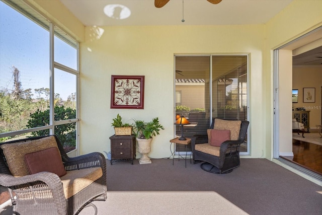 sunroom featuring ceiling fan