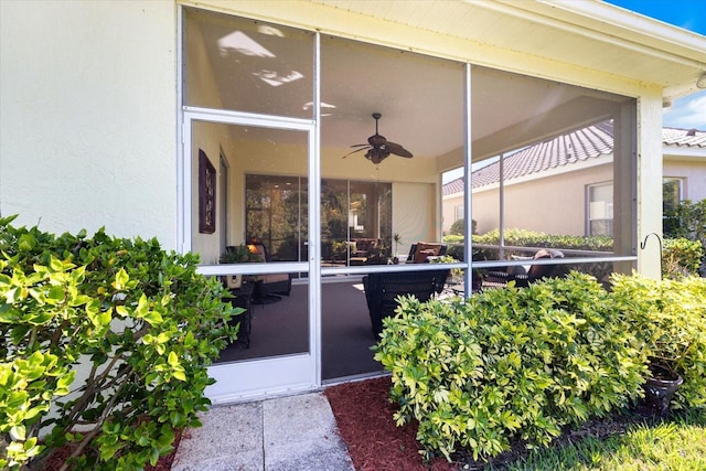 property entrance with ceiling fan