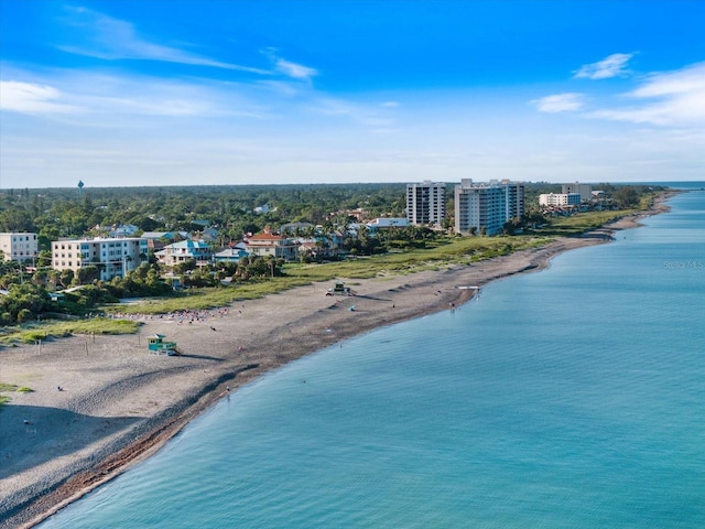 drone / aerial view featuring a water view and a beach view