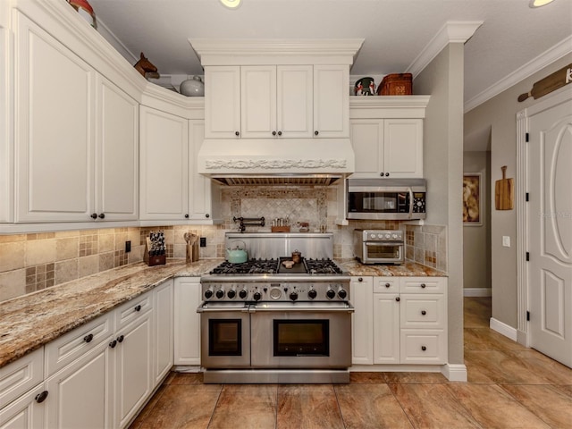 kitchen featuring decorative backsplash, custom exhaust hood, ornamental molding, stainless steel appliances, and light stone countertops