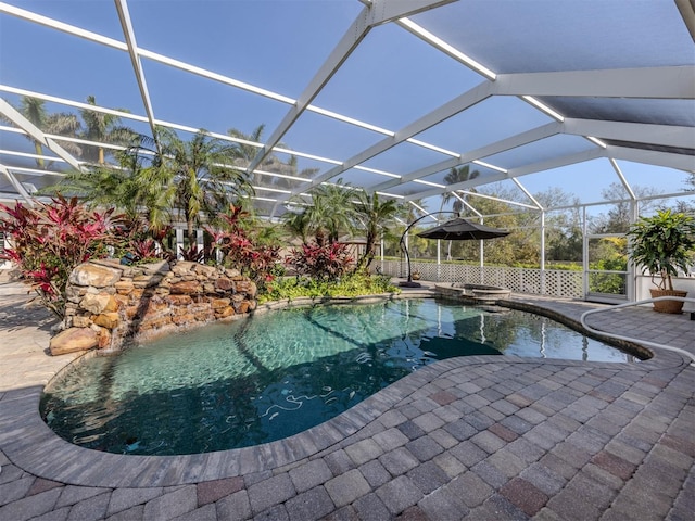 view of pool with a patio and glass enclosure