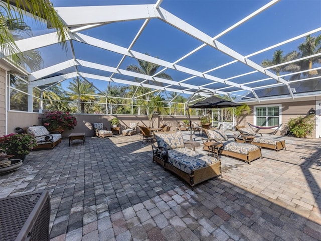 view of patio / terrace with an outdoor living space and a lanai