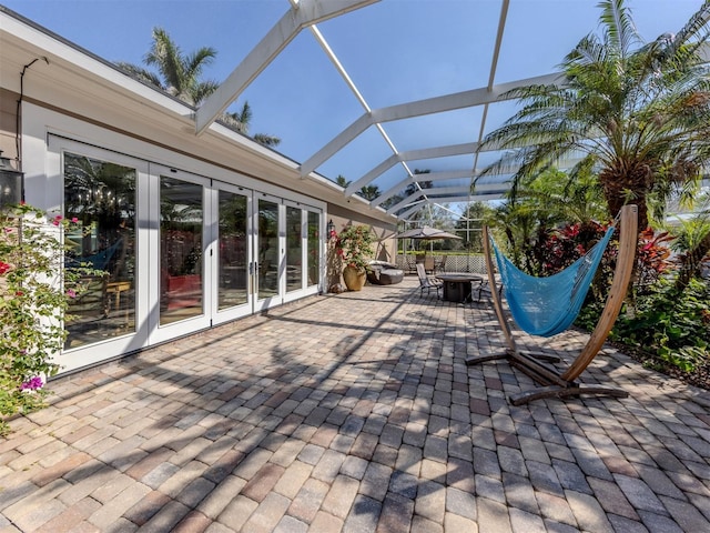 view of patio / terrace featuring french doors and glass enclosure