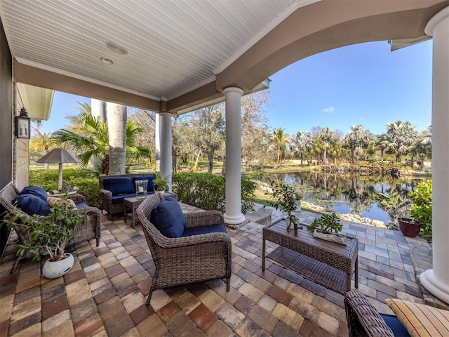 view of patio / terrace with a water view and an outdoor living space