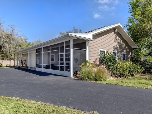 view of side of property with a sunroom