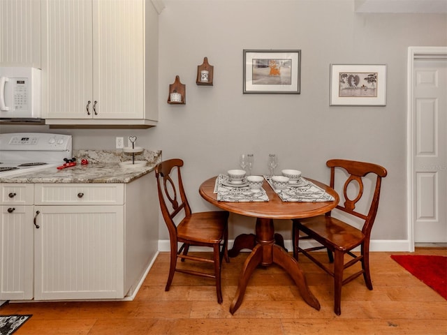 dining area with light wood-type flooring