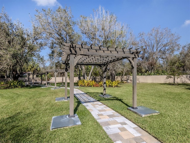 surrounding community featuring a pergola and a lawn