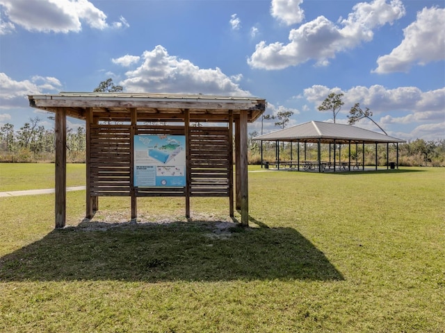 surrounding community with a gazebo and a yard