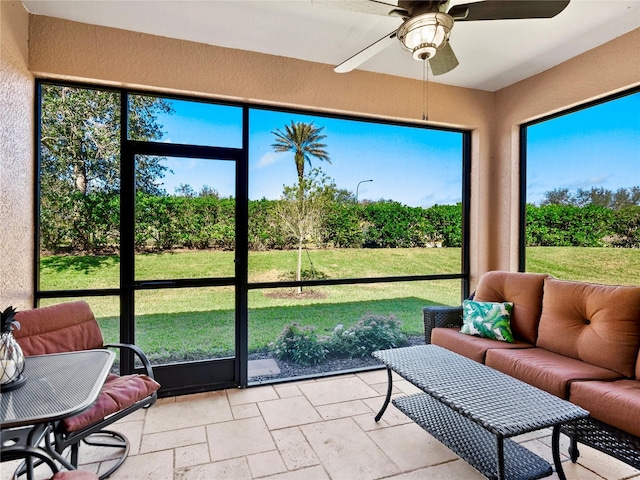 sunroom featuring ceiling fan