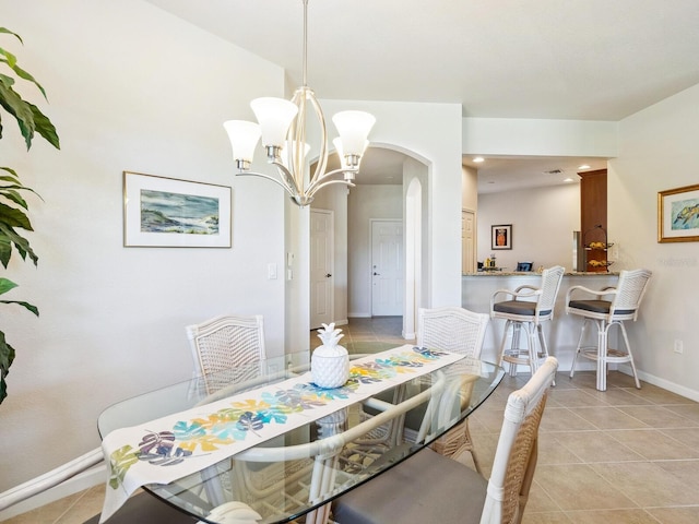 dining area featuring a notable chandelier and light tile patterned floors