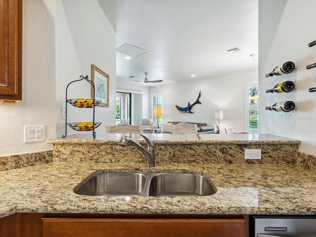 kitchen with light stone counters and sink