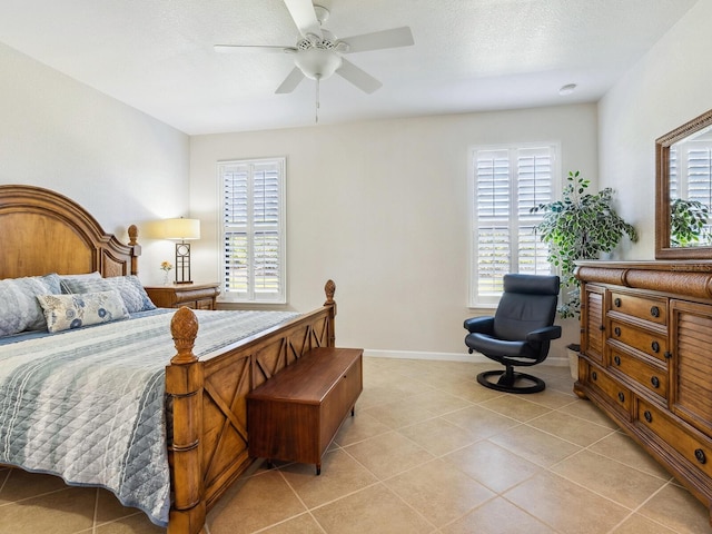 tiled bedroom with ceiling fan and a textured ceiling