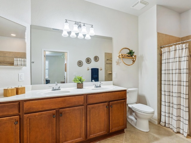 bathroom with tile patterned floors, toilet, a shower with shower curtain, and vanity