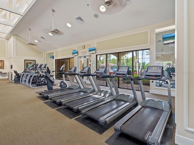 exercise room with ceiling fan, high vaulted ceiling, and carpet