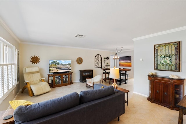 living room with a chandelier, ornamental molding, visible vents, and baseboards