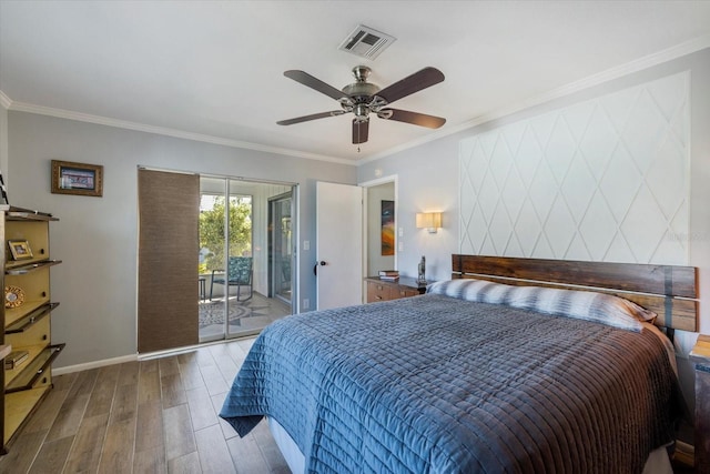 bedroom featuring wood finished floors, visible vents, baseboards, access to exterior, and crown molding