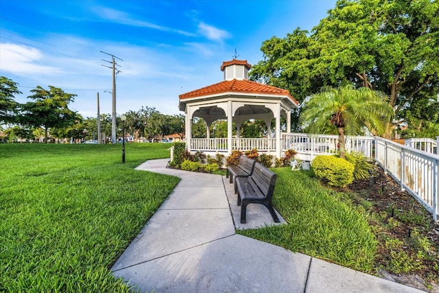 surrounding community featuring a lawn, a gazebo, and fence