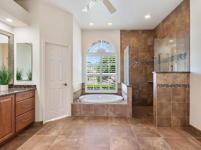 bathroom featuring ceiling fan, vanity, and separate shower and tub