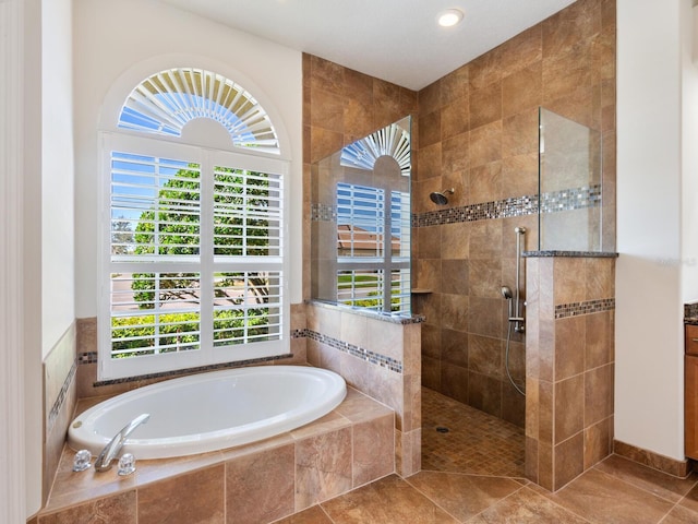 bathroom featuring shower with separate bathtub