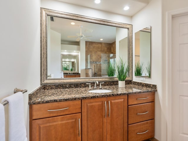 bathroom featuring vanity, ceiling fan, and a shower with shower door