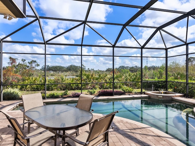 view of pool featuring an in ground hot tub, a lanai, and a patio area