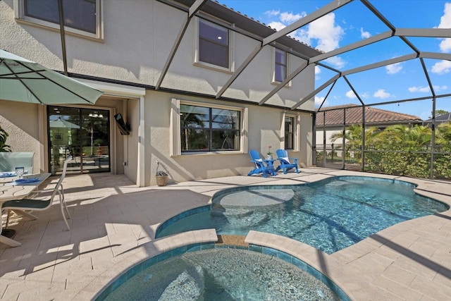 view of swimming pool featuring an in ground hot tub, a lanai, and a patio