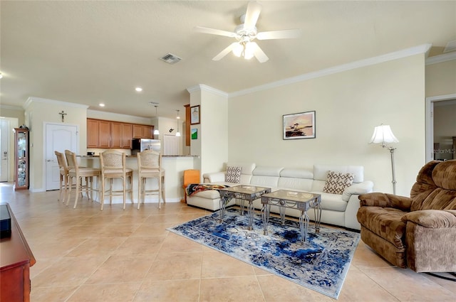 tiled living room featuring ornamental molding and ceiling fan