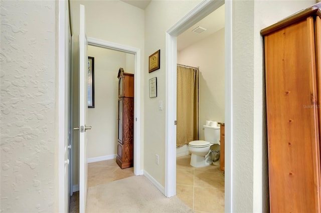 hall with light tile patterned floors