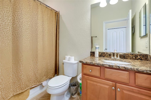 bathroom with vanity, tile patterned floors, and toilet