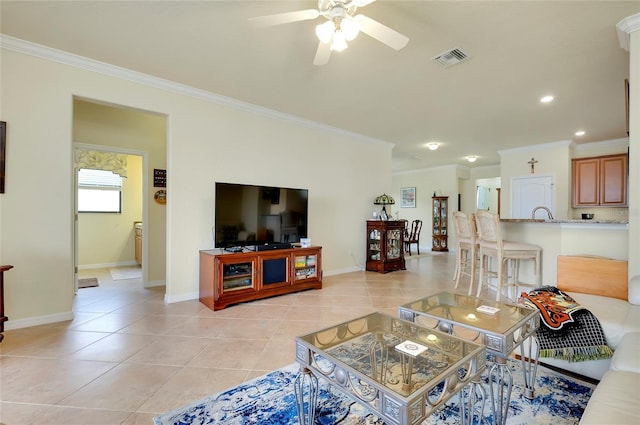 tiled living room featuring ornamental molding and ceiling fan