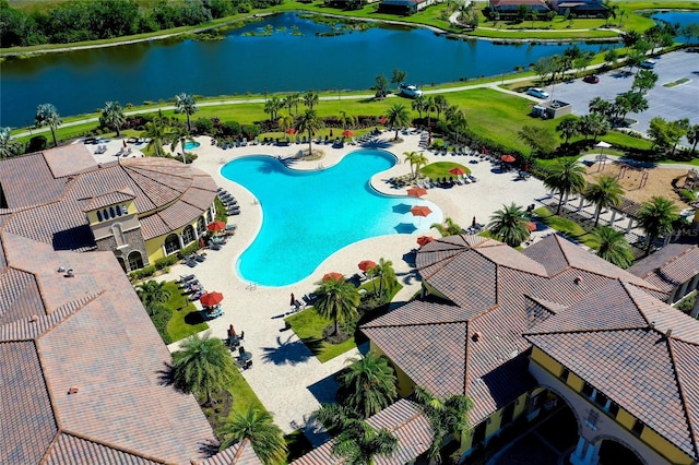 view of pool featuring a water view and a patio