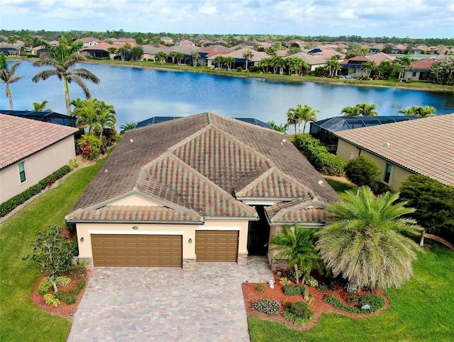 drone / aerial view featuring a water view and a residential view