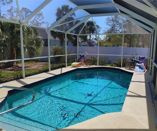 view of swimming pool with a lanai, fence, and a fenced in pool