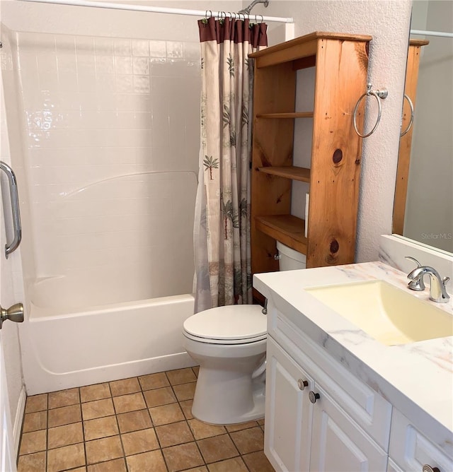 bathroom featuring vanity, shower / tub combo with curtain, toilet, a textured wall, and tile patterned floors