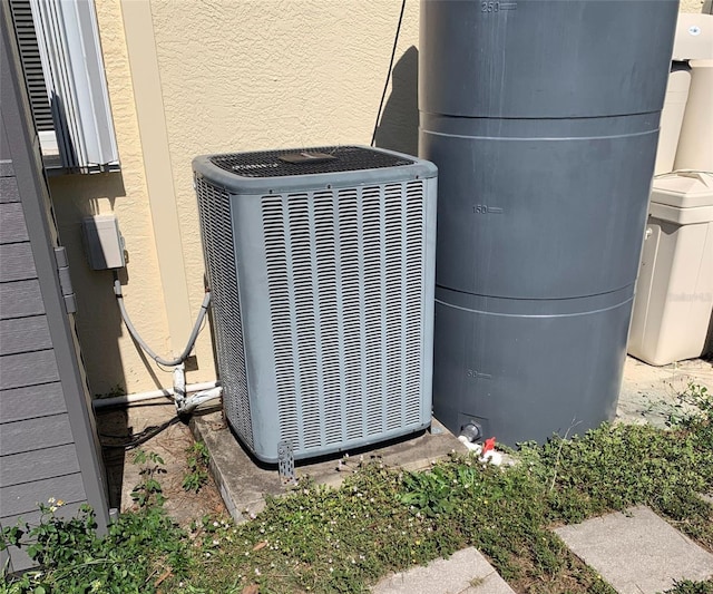 details featuring stucco siding and cooling unit