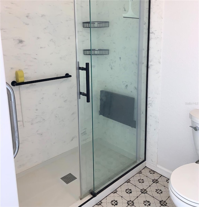 bathroom with toilet and a stall shower