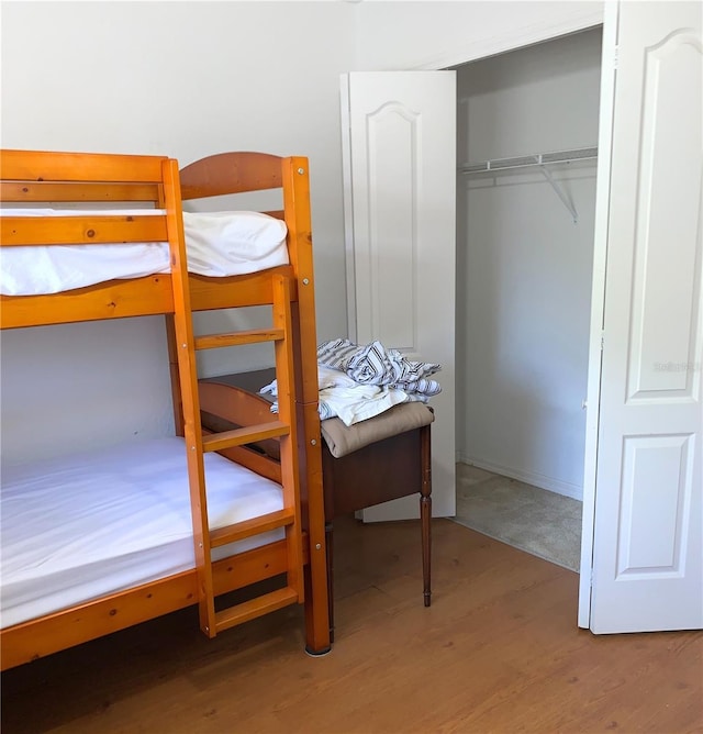 bedroom featuring a closet and wood finished floors
