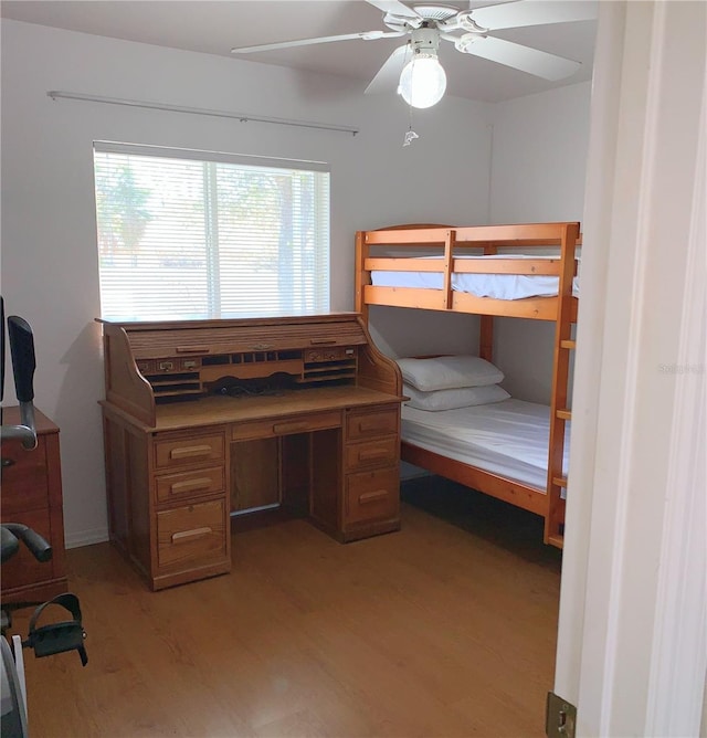 bedroom with light wood-style flooring and a ceiling fan